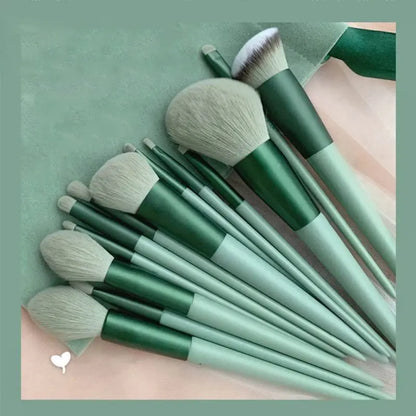 Set of green makeup brushes on a matching green background